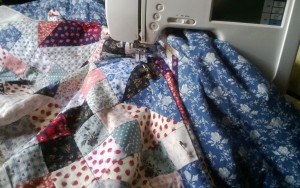 Checking whether the quilt fits under the arm of my friend's tiny machine